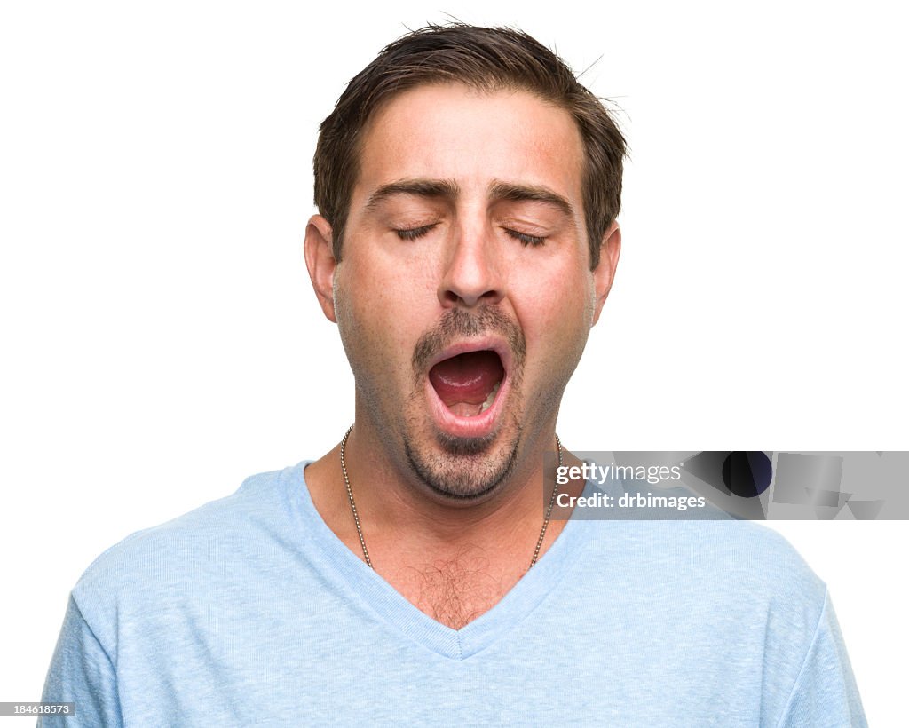 A Tired Man Wearing A Blue Top Is Yawning High-Res Stock Photo - Getty ...