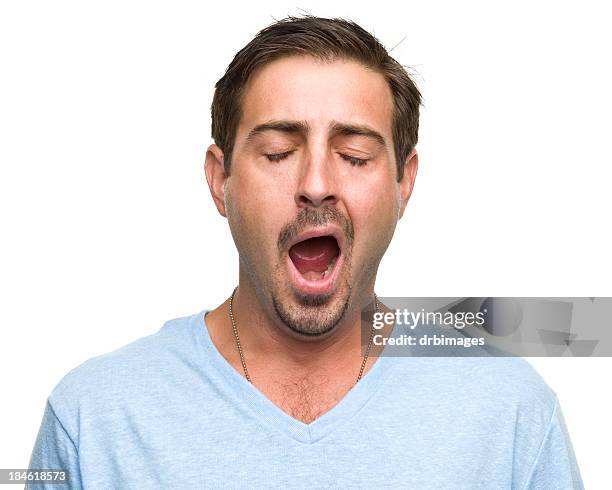 a tired man wearing a blue top is yawning  - hair part stock pictures, royalty-free photos & images