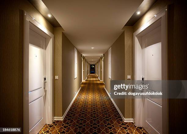 hotel corridor - illuminated corridor stock pictures, royalty-free photos & images