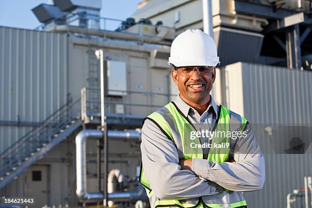 engineer standing near power generator - black helmet stock pictures, royalty-free photos & images