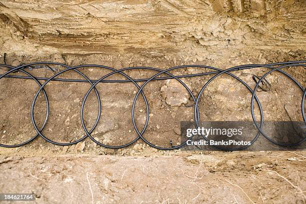 geothermal pipe coils at the bottom of a trench - geothermische centrale stockfoto's en -beelden