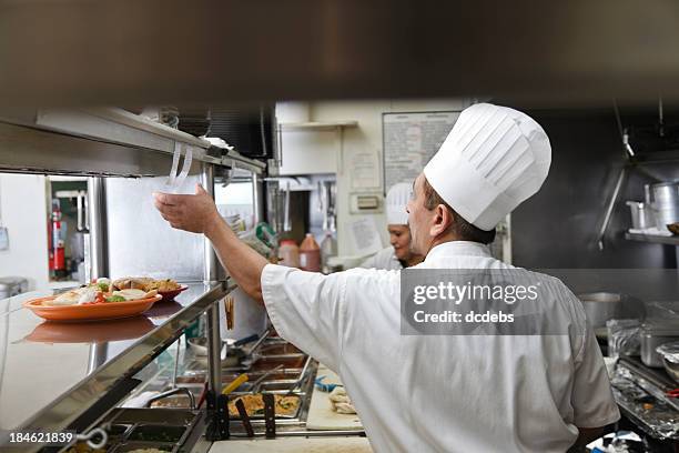 cooks in kitchen of mexican restaurant - restaurant ticket holder stock pictures, royalty-free photos & images