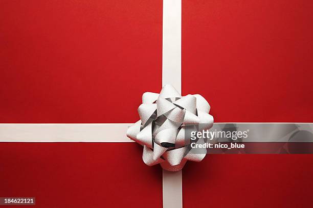 silver bow on red - generic holiday stock pictures, royalty-free photos & images
