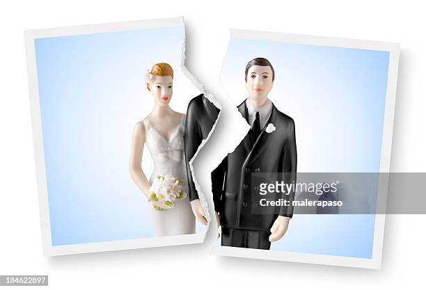 divorce. torn photograph of wedding cake topper. - relationship difficulties photos stock pictures, royalty-free photos & images