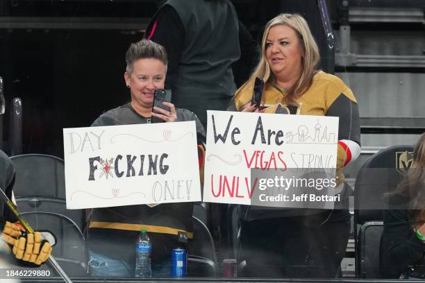 Vegas Golden Knights fans display signs during warmups prior to a game against the San Jose Sharks at T-Mobile Arena on December 10, 2023 in Las...
