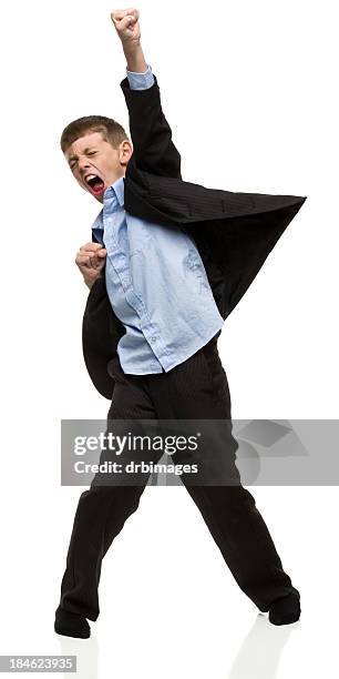 junge trägt anzug mit faust in der luft - faust in die luft stoßen stock-fotos und bilder