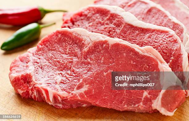 slices of new york strip steak on cutting board - beef stock pictures, royalty-free photos & images