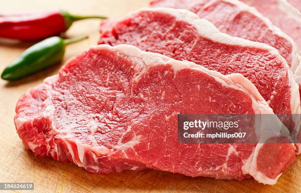 slices of new york strip steak on cutting board - meat bildbanksfoton och bilder