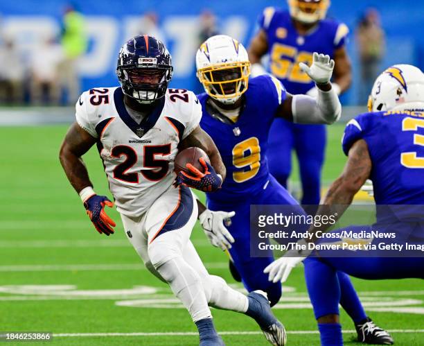 Denver Broncos running back Samaje Perine on a run after a catch against Los Angeles Chargers linebacker Kenneth Murray Jr. And safety Derwin James...