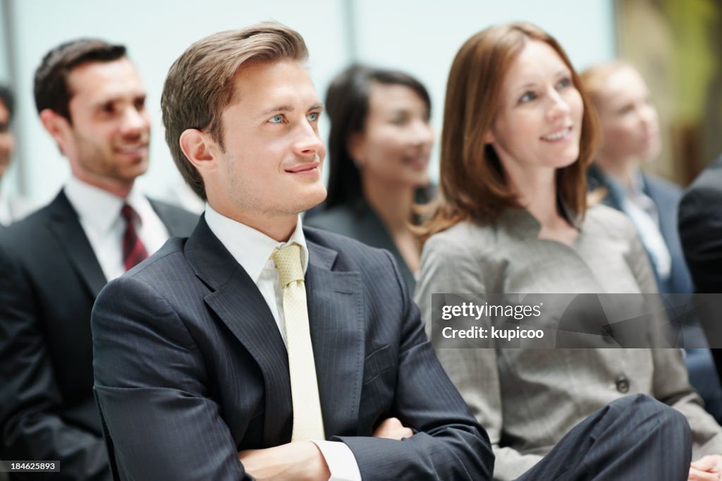 Business man attending conference with colleagues