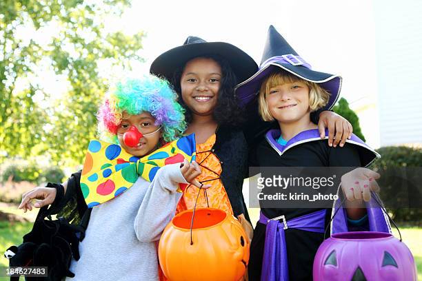 halloween kids in costumes smiling - toneelkostuum stockfoto's en -beelden