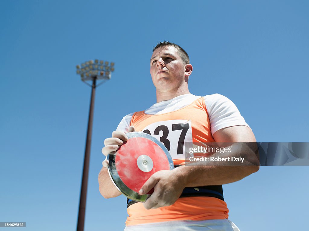 Athlete with discus in arena