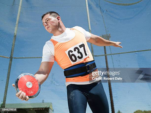 athlete with discus in arena - discus stock pictures, royalty-free photos & images