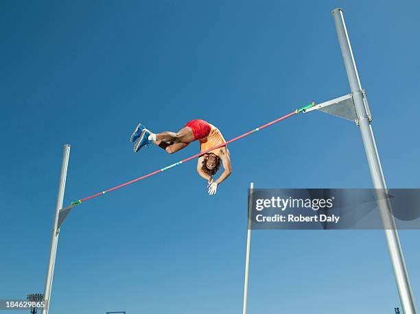 athlet in der luft, die pole vault - hochsprung stock-fotos und bilder