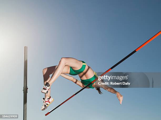 athlete high jumping in an arena - track and field event 個照片及圖片檔