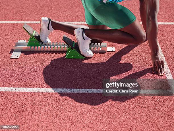 racer at start line on track - track starting block stock pictures, royalty-free photos & images