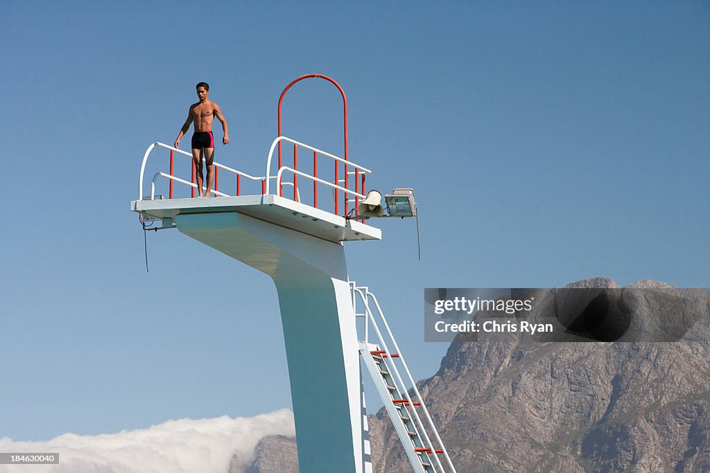 Diver standing on a diving board in a scenic location