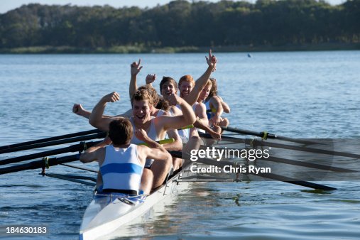 Athletes in a crew row boat cheering Athletes in a crew row boat cheering