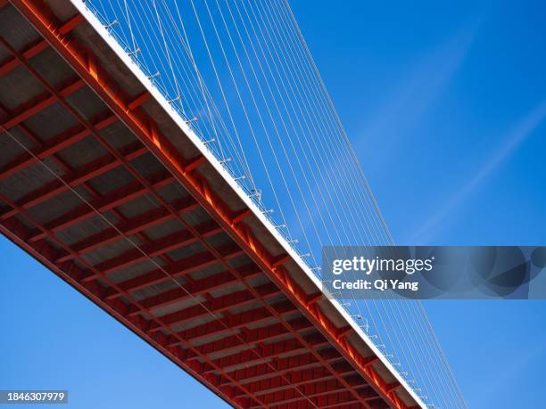 low angle view of red suspension bridge - regency frame stock pictures, royalty-free photos & images