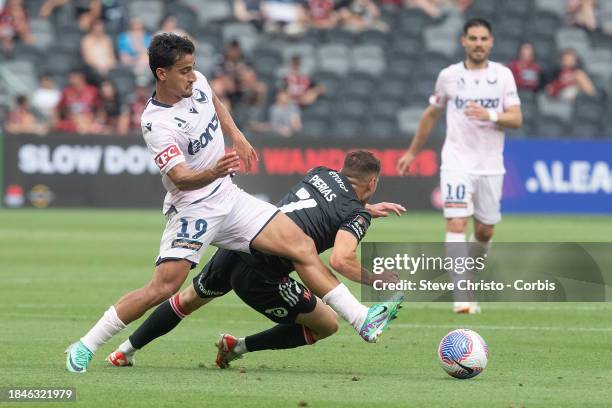 Daniel Arzani of the Victory completes for the ball with Wanderers Dylan Pierias during the A-League Men round seven match between Western Sydney and...