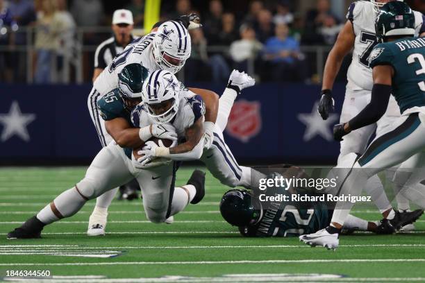 Tony Pollard of the Dallas Cowboys is tackled by Marlon Tuipulotu of the Philadelphia Eagles during the fourth quarter at AT&T Stadium on December...