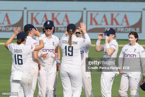 Charlie Dean of England celebrates the wicket of Yastika Bhatia of India with her teammates during day 1 of the Test match between India Women and...