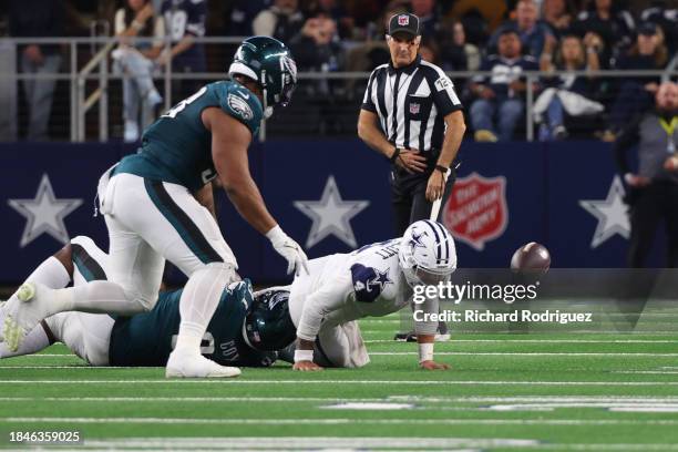 Fletcher Cox of the Philadelphia Eagles forces a fumble by Dak Prescott of the Dallas Cowboys during the third quarter at AT&T Stadium on December...