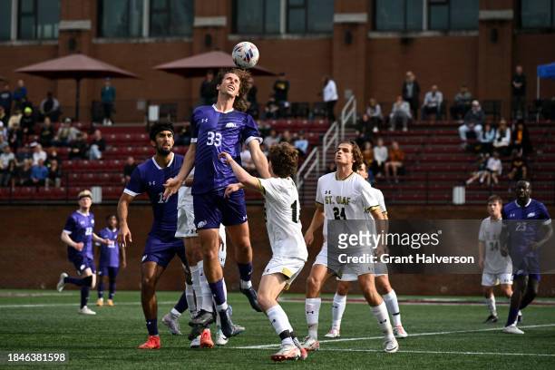 Defender Simon Kalinauskas of the Amherst Mammoths competes for a header against the St. Olaf Oles during the 2023 Division III Men's Soccer...