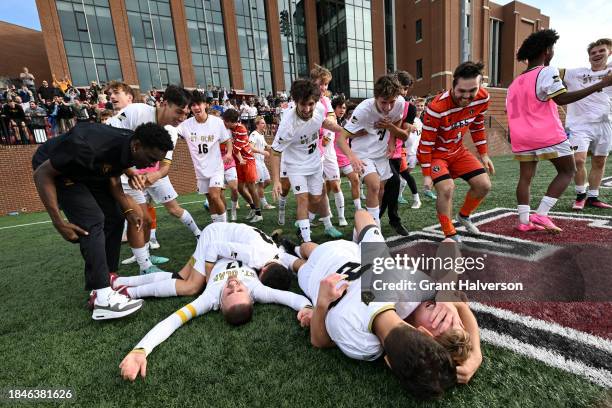 The St. Olaf Oles celebrate defeating the Amherst Mammoths during the 2023 Division III Men's Soccer Championship at Donald J. Kerr Stadium on...