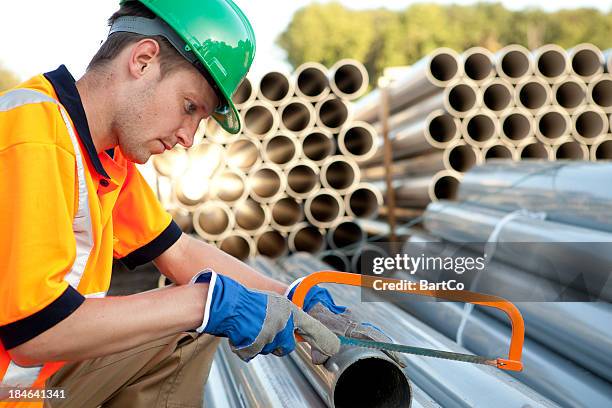 pipefitter at work with pvc pipes. sewage assembly. - pvc stockfoto's en -beelden