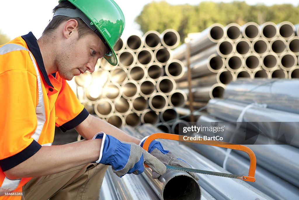 Pipefitter at work with pvc pipes. Sewage assembly.