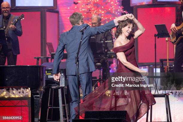Michael W. Smith and Amy Grant perform on stage during the Christmas Live concert at Smart Financial Centre on December 10, 2023 in Sugar Land, Texas.