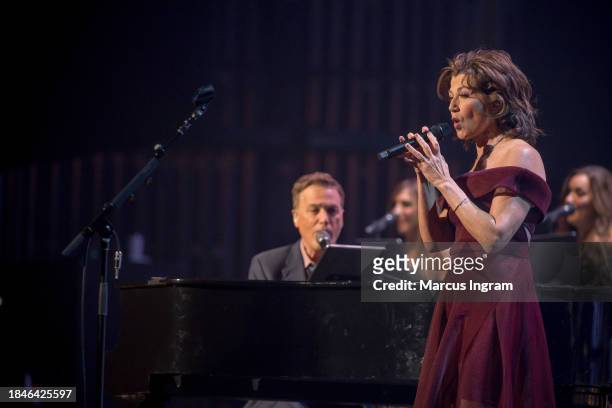 Michael W. Smith and Amy Grant perform on stage during the Christmas Live concert at Smart Financial Centre on December 10, 2023 in Sugar Land, Texas.
