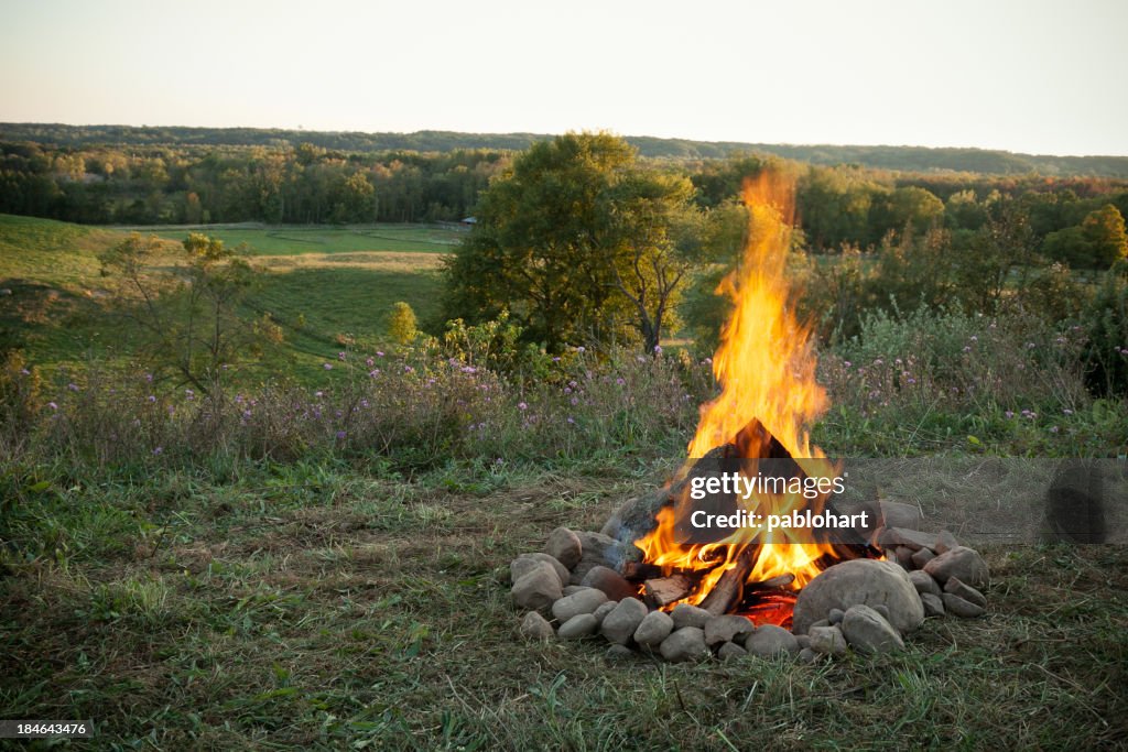 Glowing campfire overlooking the countryside