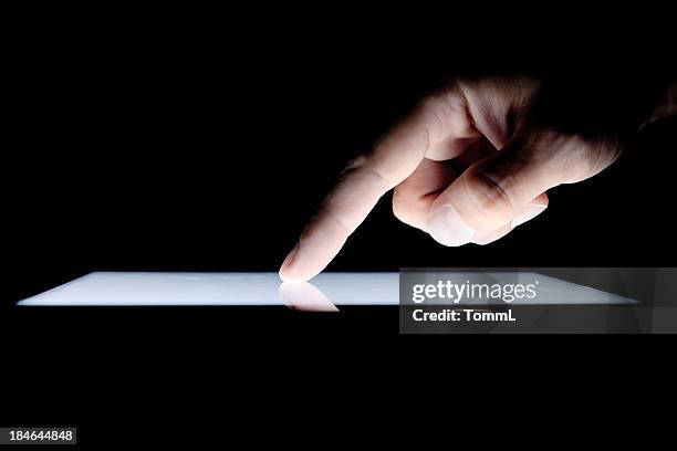 hand on tablet pc - finger tablet stock pictures, royalty-free photos & images