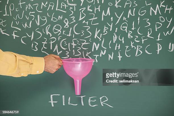 searching and filtering words on blackboard via funnel - lighting technique bildbanksfoton och bilder
