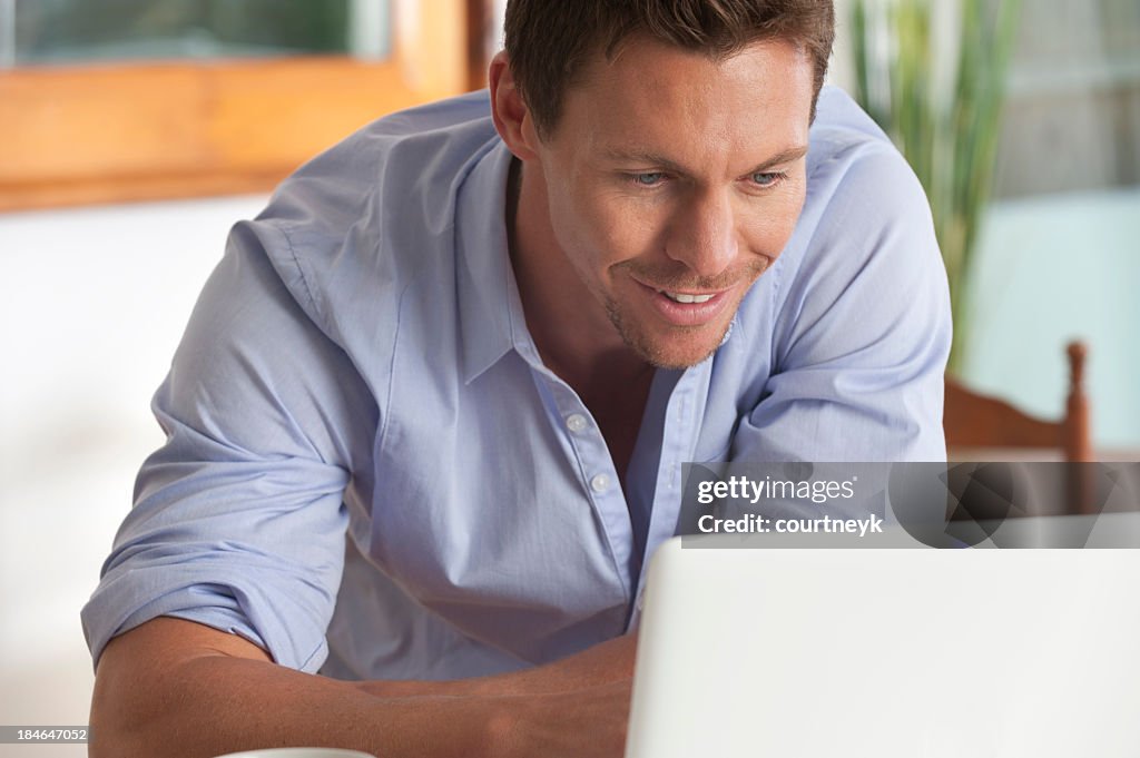 Happy man working on a laptop