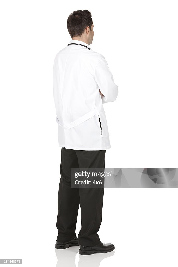 Rear view of a male doctor standing with arms crossed