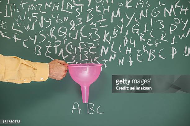 funnel in human hand searching filtering words written on blackboard - horizontal funnel stock pictures, royalty-free photos & images