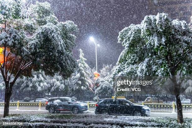 Vehicles are driven on a road during a snowfall on December 10, 2023 in Yuncheng, Shanxi Province of China.