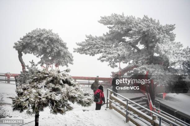 Tourists visit Huashan Mountain covered by snow on December 11, 2023 in Weinan, Shaanxi Province of China. Heavy snow hit northern China on December...