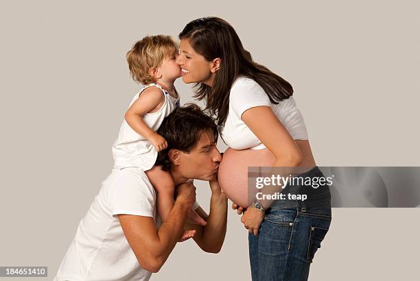 young parents expecting another child - studio kiss stock pictures, royalty-free photos & images