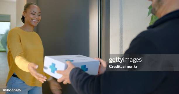 woman receiving medicine at home - top customer service stock pictures, royalty-free photos & images