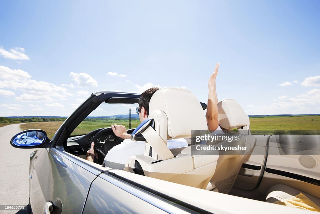 Couple travelling in a Convertible car