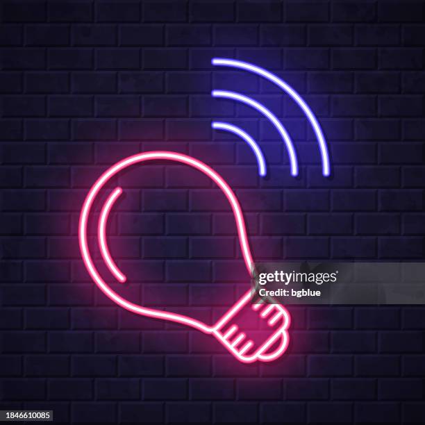 smart light bulb. glowing neon icon on brick wall background - led light pattern stock illustrations