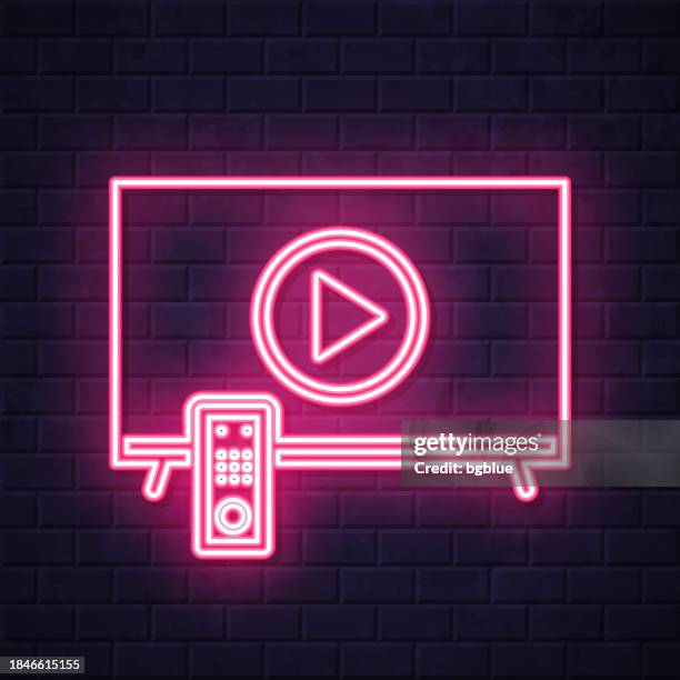 tv with play button. glowing neon icon on brick wall background - switch on wall stock illustrations