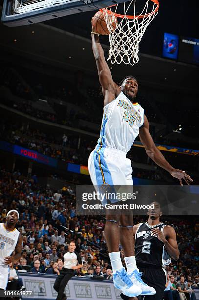 Kenneth Faried of the Denver Nuggets dunks against the San Antonio Spurs on October 14, 2013 at the Pepsi Center in Denver, Colorado. NOTE TO USER:...