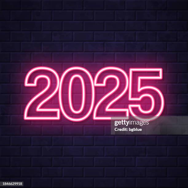 2025 - two thousand twenty-five. glowing neon icon on brick wall background - neon 2025 stock illustrations