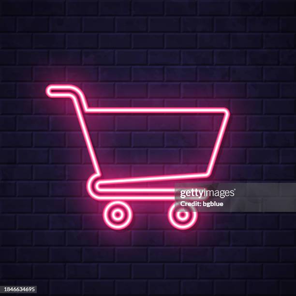 einkaufswagen. leuchtende neon-ikone auf backsteinwandhintergrund - einkaufswagen stock-grafiken, -clipart, -cartoons und -symbole