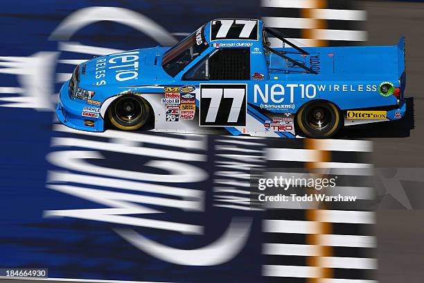 German Quiroga, driver of the NET 10 Wireless Chevrolet, during practice for the NASCAR Camping World Truck Series 14th Annual Michigan National...